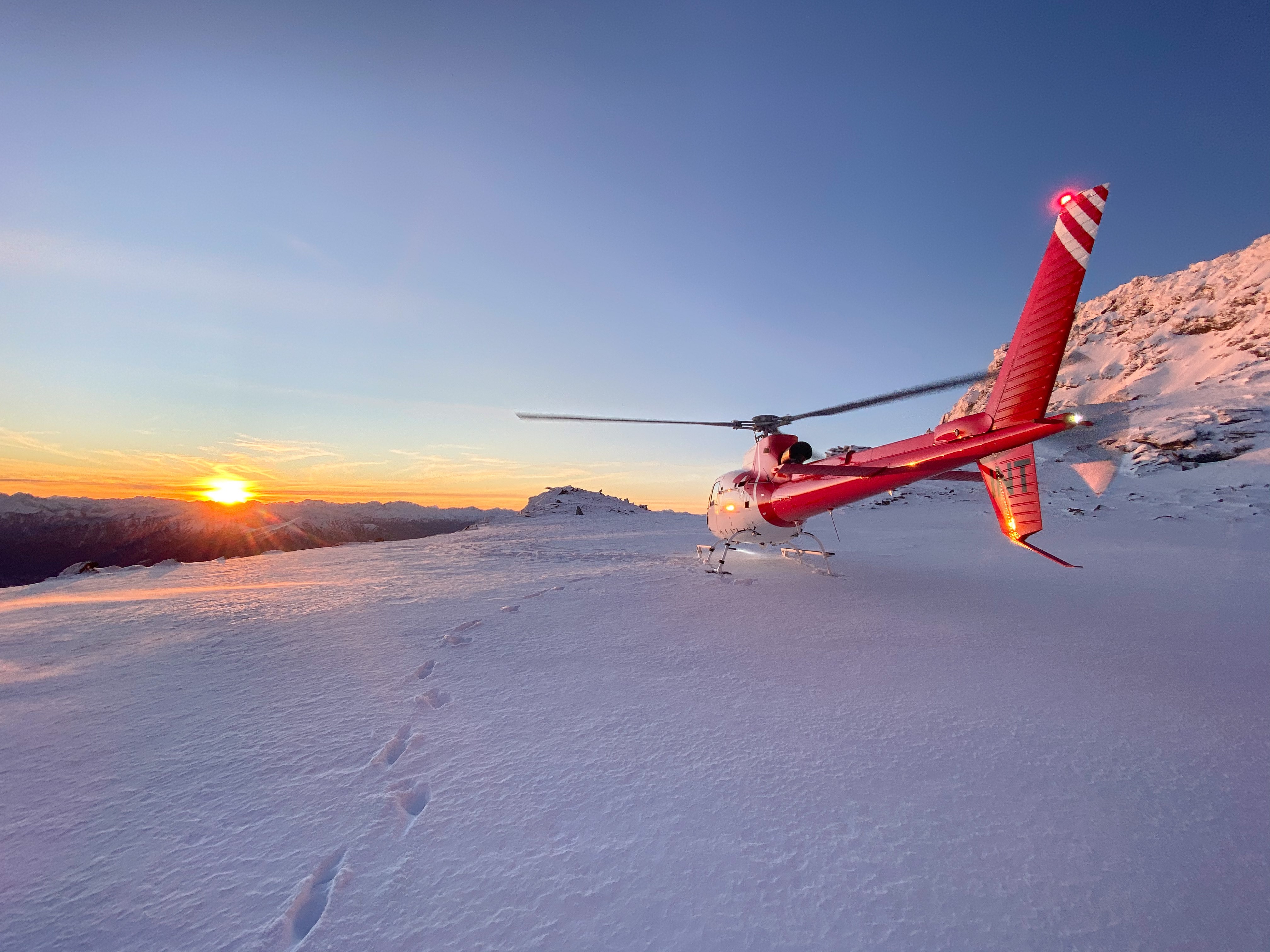 Soar above stunning landscapes as the sun sets over the Remarkables. Enjoy breathtaking views and unwind with a drink amid snow-capped peaks creating unforgettable memories.